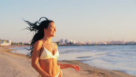 Young-Woman-in-Bikini-Swimsuit-Running-on-Beach.people,-summer-and-swimwear-concept-young-woman-in-bikini-swimsuit-on-beach