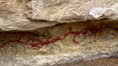 Maori-drawing-of-a-taniwha-at-the-rock-art-drawings-in-Duntroon-in-the-South-Island-of-New-Zealand