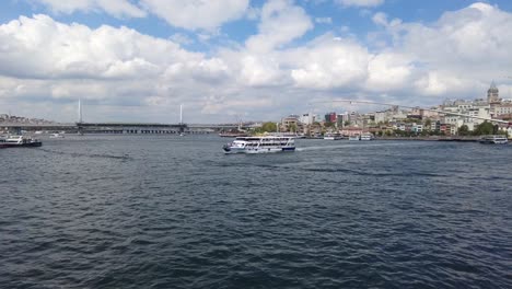 View-from-Galata-Bridge-at-the-Bosporus-Bay-in-Istanbul,-Turkey,-with-passenger-boats-floating