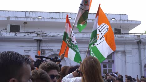 Congress-party-supporters-with-Congress-political-party-flags-waving,-Congress-win-celebration-in-Lok-Sabha-elections-at-party-headquarter-office