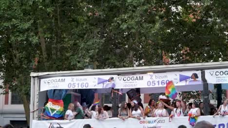 COGAM-wagon-at-a-Madrid-pride-event-parade,-showcasing-vibrant-LGBTQ+-support-and-community-spirit