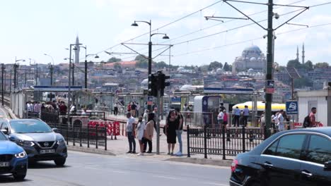 A-steady-eye-level-shot-of-cars-and-pedestrians-waiting-to-cross-the-road-in-the-urban-area-of-Istanbul