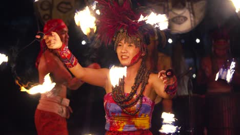 Balinese-Woman-Spins-Burning-Flame-Wheels-or-Torches-During-African-Rhythm-Fire-Dance-Performance-Show-at-Bali-Safari-And-Marine-Park,-Indonesia