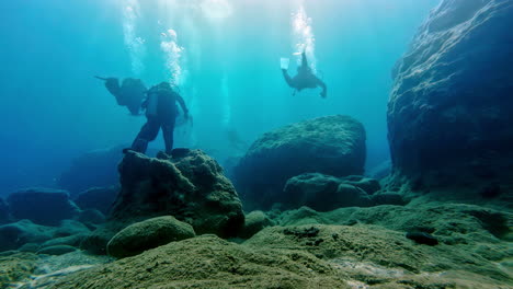 Scuba-Divers-Swimming-Underwater-In-Greece