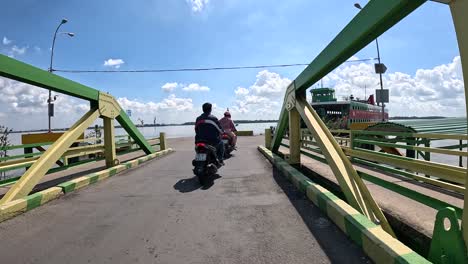 Motorbike-transportation,-ferry-official,-boarding-passenger-vehicles