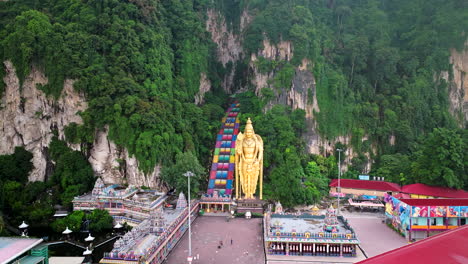 Caverns-vast-with-ceiling-high,-temple-’neath-Malaysian-open-sky,-aerial