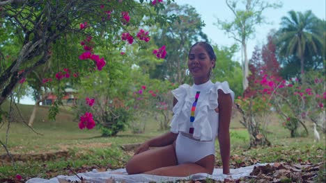 At-the-Botanical-Gardens-in-Trinidad,-a-young-girl-in-a-white-outfit-enjoys-the-bright-sunny-day