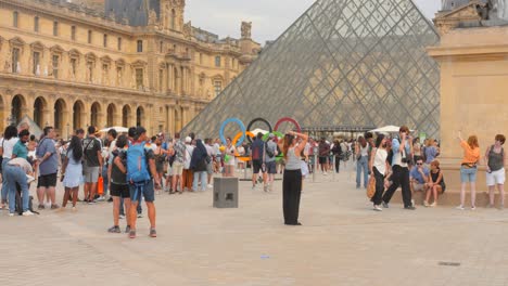 El-Logo-De-Los-Juegos-Olímpicos-Con-Los-Anillos-Simbólicos-En-El-Museo-Del-Louvre