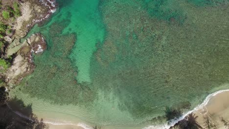 Stunning-aerial-view-of-the-white-sand-and-crystal-clear-beach-of-Tobago-in-the-Caribbean