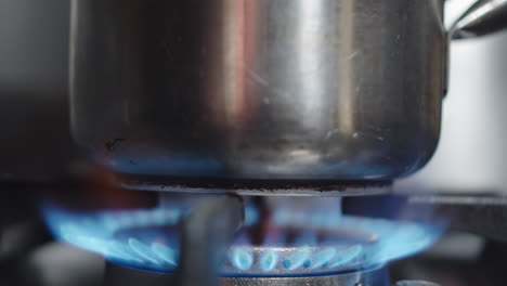 Beautiful-slow-motion-shot-as-the-fire-burns-on-an-industrial-stove-burner-in-a-Mexican-food-restaurant