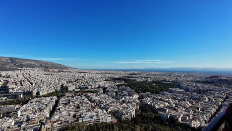 Pan-shot-of-Mount-Lycabettus-from-a-viewpoint-with-beautiful-cityscape-during-daytime-in-Athens,-Greece