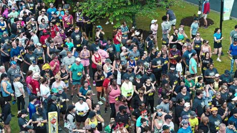 Large-Crowd-Of-People-Participating-In-The-Tacos-And-Tequila-5K-Race-In-Suwanee,-Georgia,-USA---Drone-Shot