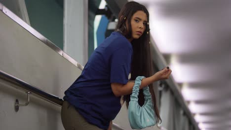 Clad-in-street-style-fashion,-a-young-Latina-walks-through-a-charming-pedestrian-overpass-in-Port-of-Spain,-Trinidad