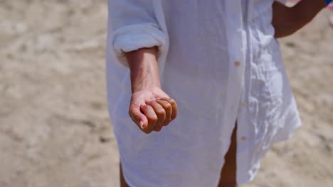 Woman-open-palm-and-hold-shells-in-hand-from-Balearic-sea,-Mallorca