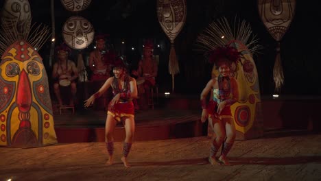 Balinese-African-Rhythm-Fire-Dance-Performance-Show-at-Bali-Safari-And-Marine-Park,-Indonesia---Two-Girls-Dancing-with-Drums-Music-at-Night