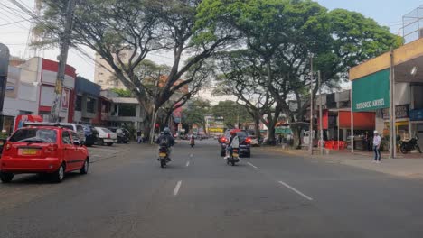 Street-Traffic-in-Downtown-Neighborhood-of-Cali,-Colombia,-Car-Driver-Point-of-View