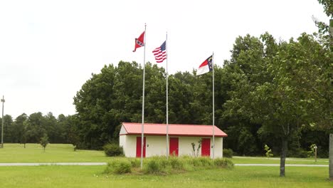 Civil-War-battle-site-with-the-USA,-Confederate,-and-North-Carolina-state-flags-blowing-in-the-wind