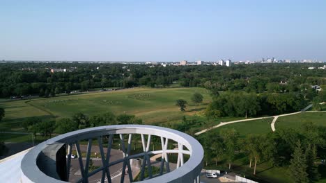 Aerial-Drone-View-Over-The-Leaf-Conservatory-Revealing-Games-and-Winnipeg-Skyline