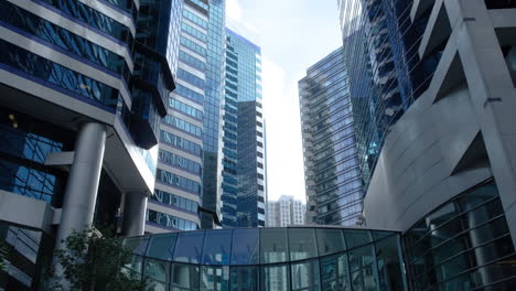 Modern-business-architecture-with-glass-and-steel-walls-reflecting-sky-clouds