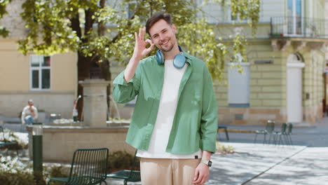 Caucasian-man-looking-approvingly-at-camera-showing-OK-gesture-positive-like-sign-Okay-celebrate-win