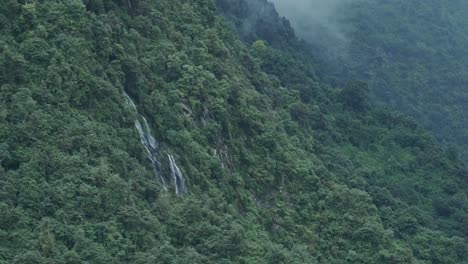 Nature-Background-of-Rainforest-Waterfall-with-Copy-Space,-Elevated-Aerial-View-of-Waterfalls-in-the-Mountains,-Wide-Angle-Shot-from-Above-the-Tree-Tops-in-Green-Lush-Nature-Background-in-Nepal