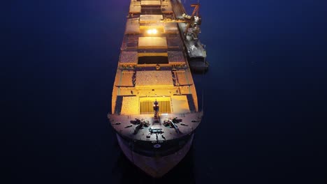 Seagulls-flying-over-a-cargo-ship-stopped-at-La-Herradura-beach,-Coquimbo,-Chile