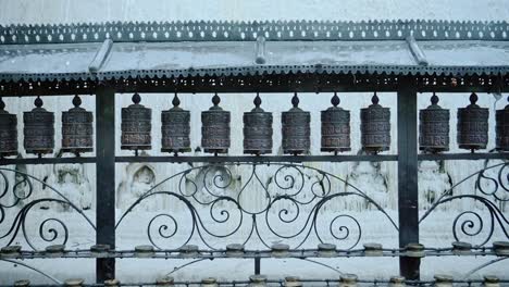 Kathmandu-Tibetan-Buddhist-Prayer-Wheels-in-Nepal-at-Monkey-Temple,-a-Buddhist-Temple-used-for-Buddhism-Praying-at-a-Popular-Buddhist-Religious-Temple-Site,-Close-Up-of-Wheels-Spinning