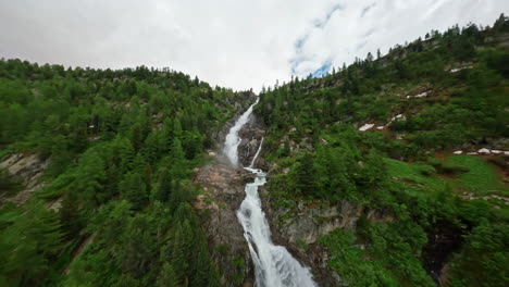 A-stunning-waterfall-cascades-down-a-lush-green-mountain