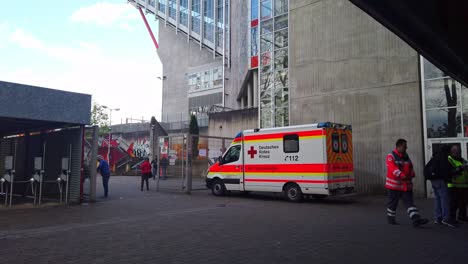 Standby-Ambulance-and-Paramedic-Outside-Football-Stadium-as-Medical-Emergency-Precaution