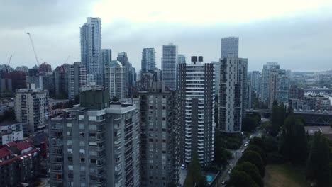 Vancouver-downtown-skyline-with-modern-high-rise-buildings-and-cloudy-sky,-aerial-view