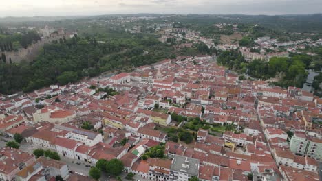 Aerial-view-of-historic-town-of-Tomar-with-red-tiled-roofs,-Portugal