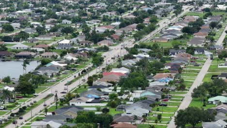 Cape-Coral-Neighborhood-with-traffic-on-main-highway-during-sunny-day,-Florida