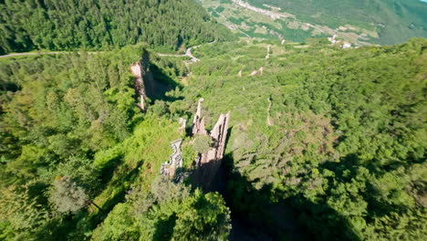 The-piramidi-di-terra-di-segonzano-in-a-lush-green-valley,-aerial-view