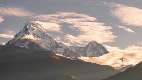 Himalayas-Mountains-Sunset-Timelapse-in-Nepal,-Time-Lapse-of-Snowcapped-Snowy-Mountain-Range-with-Big-Tall-High-Peaks-and-Summits-at-Sunset-with-Clouds-Moving-in-Beautiful-Golden-Orange-Sunlight