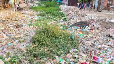 Dry-canal-filled-with-plastic-waste-at-Dhaka,-Bangladesh