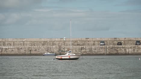 A-small-sailing-boat-docked-by-the-pier-in-the-sea-at-Margate