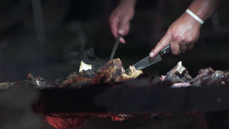 Skewering-huge-beef-ribs-on-the-grill-at-an-Argentine-asado---slow-motion