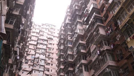 Old-Dense-Apartment-Buildings-In-Residential-Neighborhood-In-Hong-Kong,-Panning-Low-Angle-View