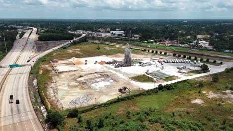 An-aerial-view-go-a-concrete-batch-plant,-on-a-partly-cloudy-day,-recorded-at-60-frames