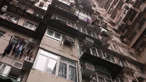 Exterior-Facade-Of-Old-Apartment-Building-In-Hong-Kong,-Low-Angle-Dolly-View