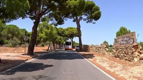 Following-a-bus,-transportation,-long-winding-rural-roads,-point-of-view-near-Poetto-beach,-Cagliari