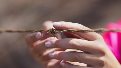 Burnt-barbed-wire-handled-delicately