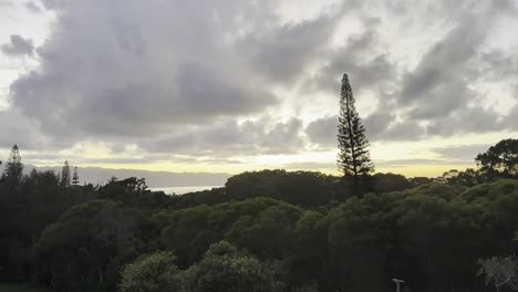 Capture-the-serene-beauty-of-a-sunset-over-Oahu's-lush,-forested-landscape