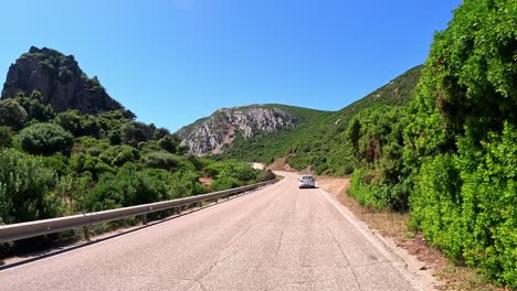 Leisure-car-drive-between-emerald-hills-in-Sardinia