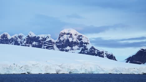 Glacier-and-Mountains-Scenery-on-Coast,-Antarctica-Mountain-Landscape,-Blue-Winter-Scene-with-Ice-and-Ocean-Sea-Water,-Antarctic-Peninsula-Coastal-Scenery-Seascape-in-Beautiful-Dramatic-Scene