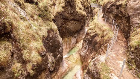 Aerial-view-of-the-Almbachklamm-waterfall-in-Garmisch-Partenkirche-during-summer-showcases-the-vibrant-display-of-colorful-foliage