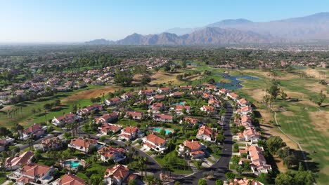 Aerial-dolly-over-home-complex-in-Palm-Springs-California-USA-with-mountains-in-background