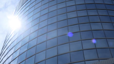 Modern-business-architecture-with-glass-and-steel-walls-reflecting-sky-clouds