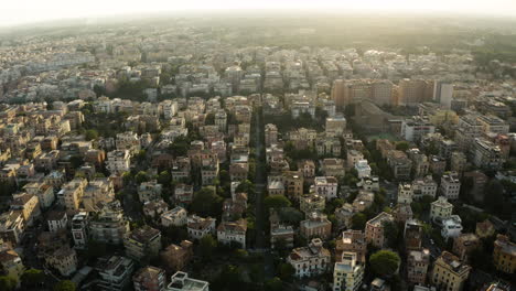 Golden-glow-from-sunset-spreads-light-across-building-rooftops-in-Trastevere-neighborhood-Rome-Italy