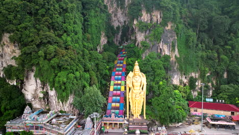 Rising-bold-from-verdant-green,-Batu-Caves-stand-tall,-serene,-aerial